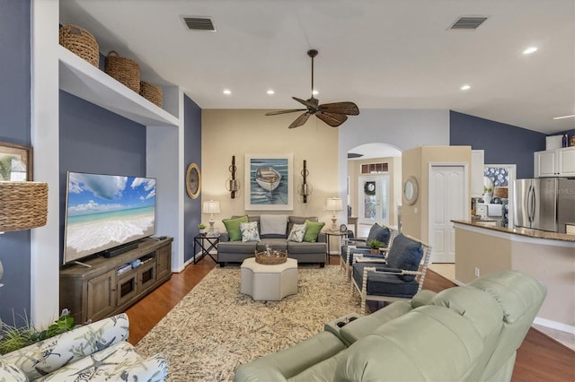 living room featuring lofted ceiling, dark wood-type flooring, and ceiling fan