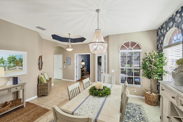 tiled dining space featuring an inviting chandelier and plenty of natural light