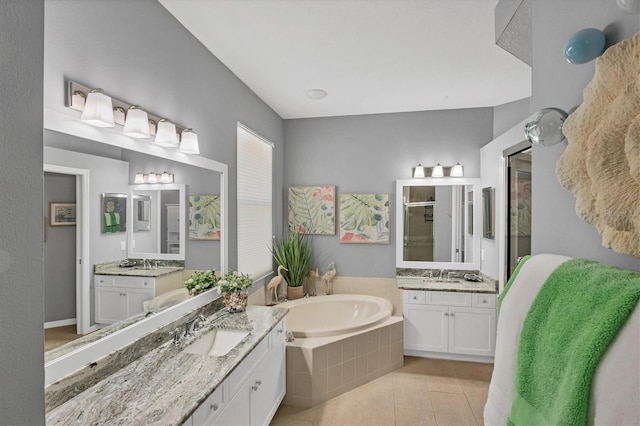 bathroom featuring tile patterned floors, independent shower and bath, and vanity