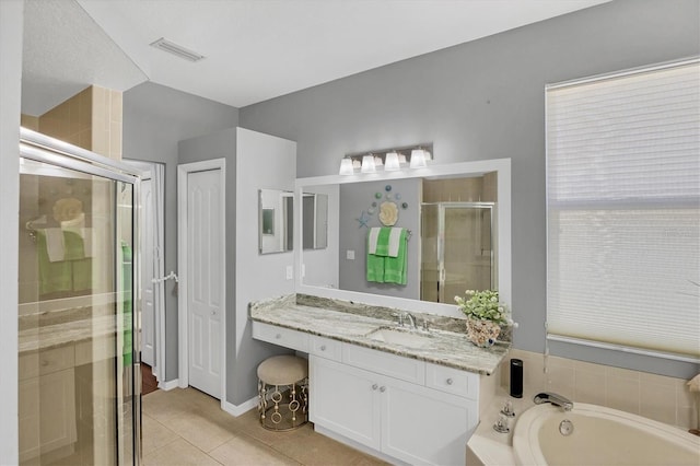 bathroom with vanity, tile patterned floors, and plus walk in shower