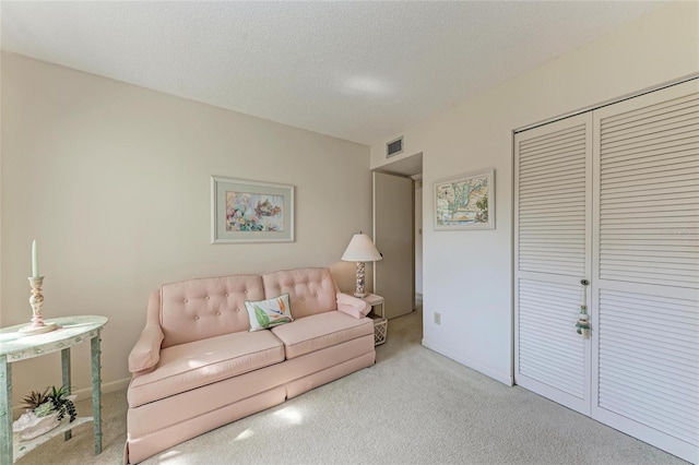 630 Bird Bay Dr E Unit 208, Venice, FL 34285 - living area with carpet flooring and a textured ceiling