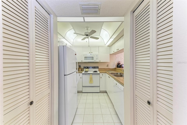 630 Bird Bay Dr E Unit 208, Venice, FL 34285 - kitchen with white appliances, light tile patterned floors, ceiling fan, light countertops, and a textured ceiling