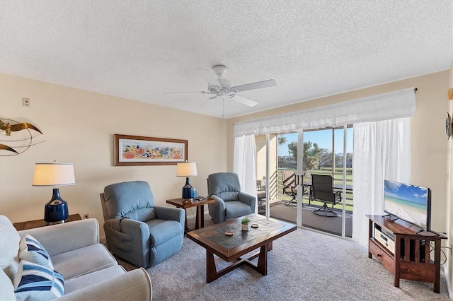 carpeted living room featuring a textured ceiling and ceiling fan