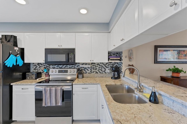 kitchen with tasteful backsplash, white cabinetry, appliances with stainless steel finishes, and sink