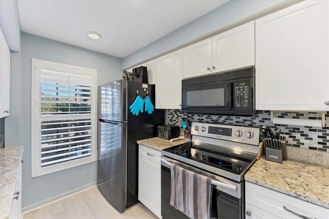 kitchen featuring tasteful backsplash, stainless steel appliances, light stone countertops, and white cabinets