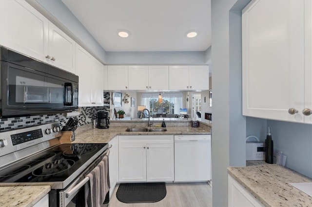 kitchen with sink, white cabinetry, light stone counters, stainless steel electric range, and white dishwasher