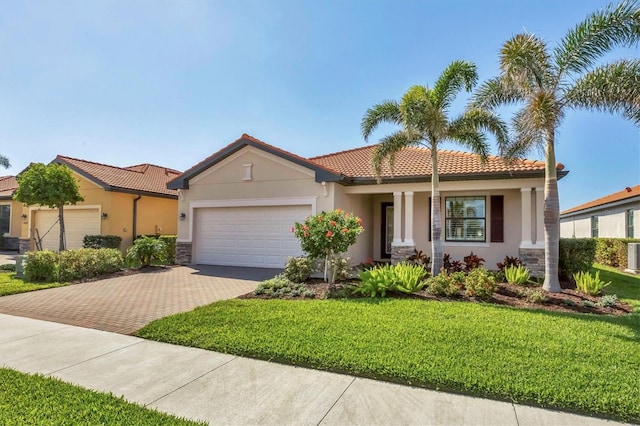 mediterranean / spanish home with a garage and a front yard