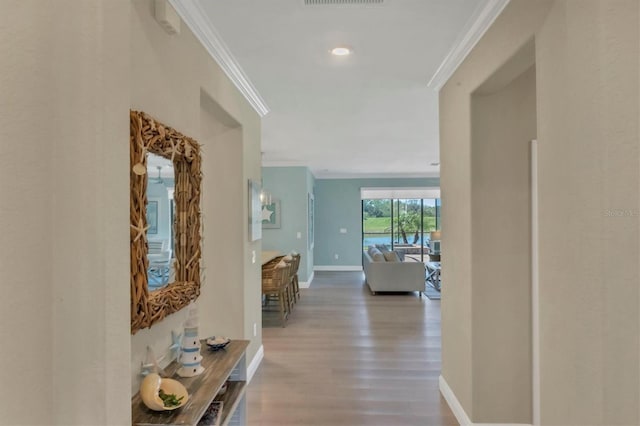 corridor with crown molding and hardwood / wood-style floors