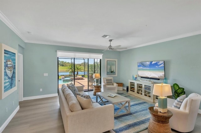 living room featuring crown molding, wood-type flooring, and ceiling fan