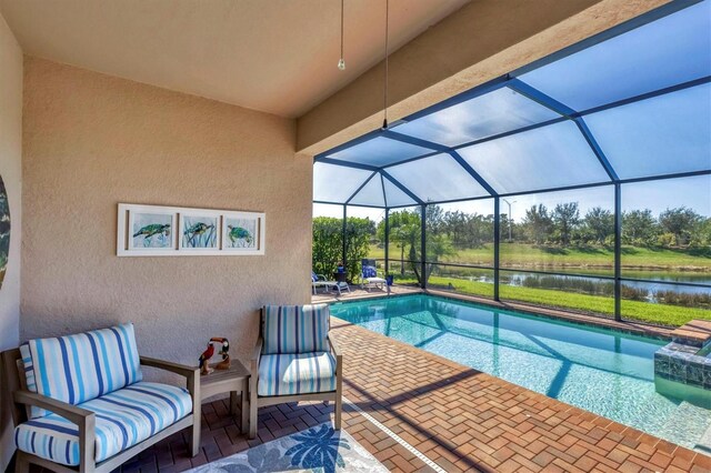 view of swimming pool featuring a water view, a patio, and glass enclosure