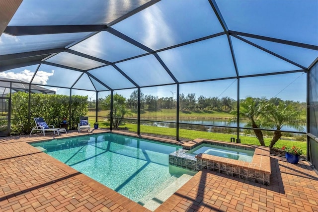 view of pool with an in ground hot tub, a water view, glass enclosure, and a patio