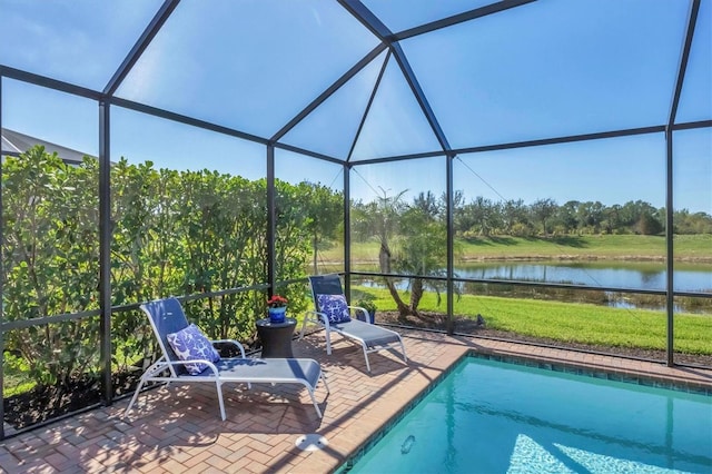 view of swimming pool with a lanai, a patio, and a water view