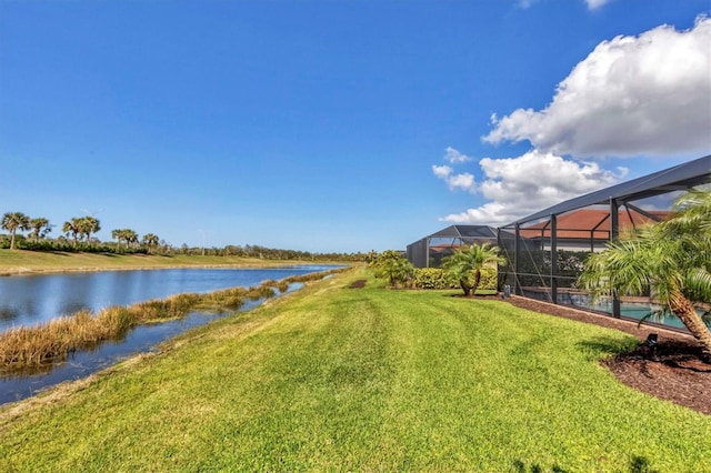 view of yard with glass enclosure and a water view