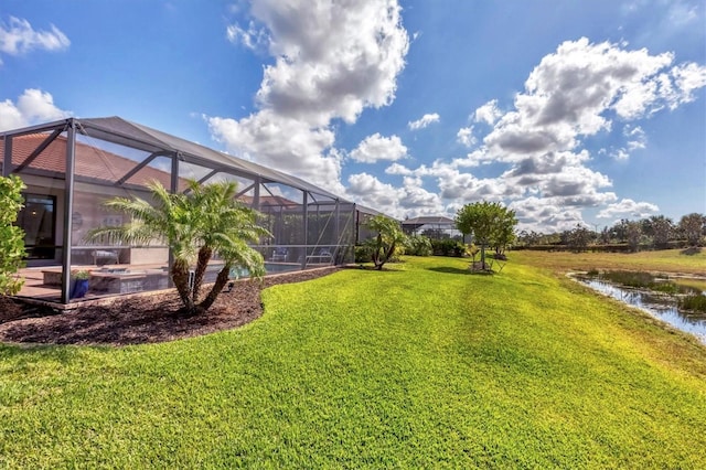 view of yard featuring a water view and a lanai