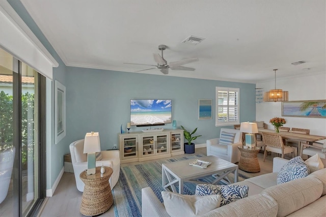 living room featuring crown molding, ceiling fan with notable chandelier, and light hardwood / wood-style floors