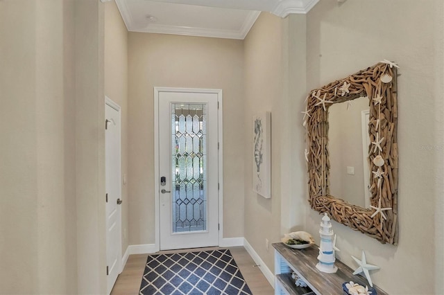 foyer entrance with wood-type flooring and ornamental molding