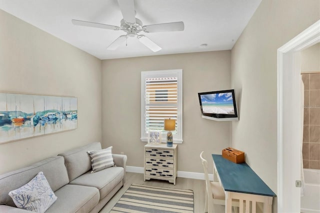 living room featuring light wood-type flooring and ceiling fan