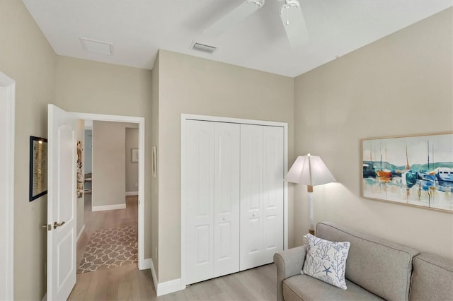 sitting room featuring ceiling fan and light wood-type flooring