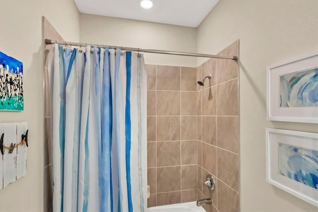 bathroom with shower / bath combination with curtain