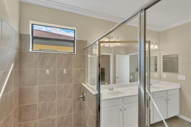 bathroom featuring ornamental molding, vanity, and a tile shower