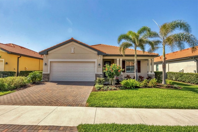 mediterranean / spanish-style house featuring a garage and a front yard