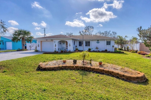 single story home featuring a garage and a front yard