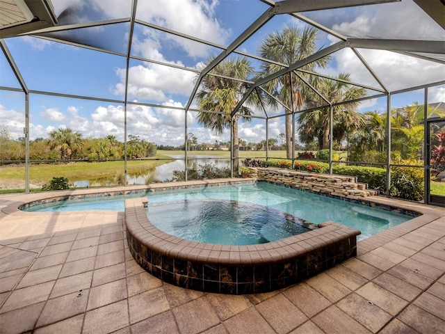 view of pool featuring a patio area, glass enclosure, and a water view