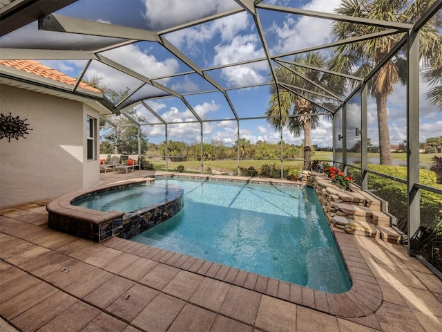 view of swimming pool with an in ground hot tub, glass enclosure, and a patio