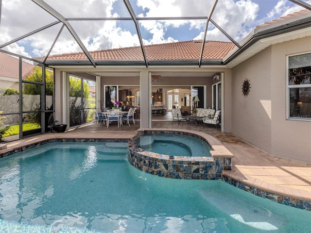 view of pool featuring a lanai, a patio, and an in ground hot tub