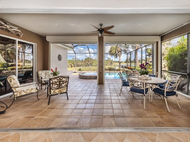 sunroom with a healthy amount of sunlight and ceiling fan