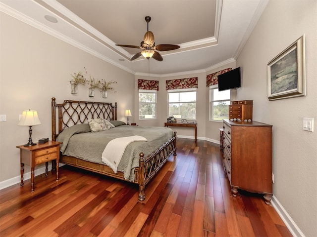 bedroom featuring crown molding, ceiling fan, dark hardwood / wood-style flooring, and a raised ceiling