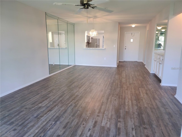 unfurnished living room with dark wood-type flooring and ceiling fan