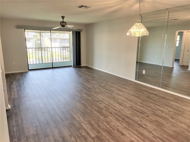 unfurnished room with dark wood-type flooring and ceiling fan