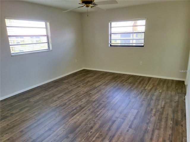 spare room with dark hardwood / wood-style floors and ceiling fan