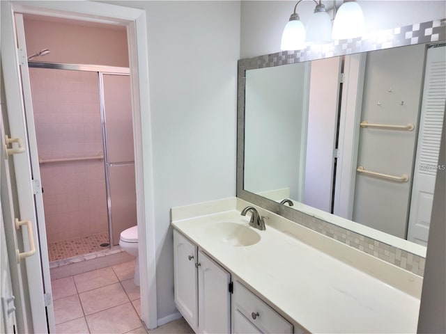 bathroom featuring vanity, an enclosed shower, tile patterned floors, and toilet