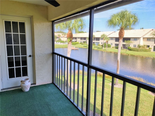 unfurnished sunroom with a water view