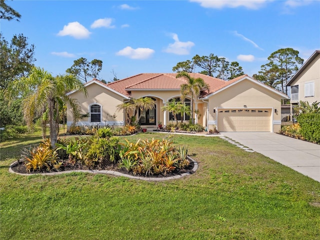 mediterranean / spanish home featuring a garage and a front lawn