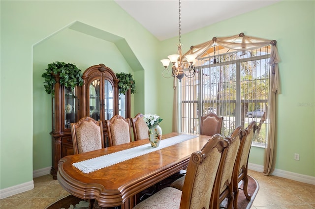 tiled dining space with an inviting chandelier