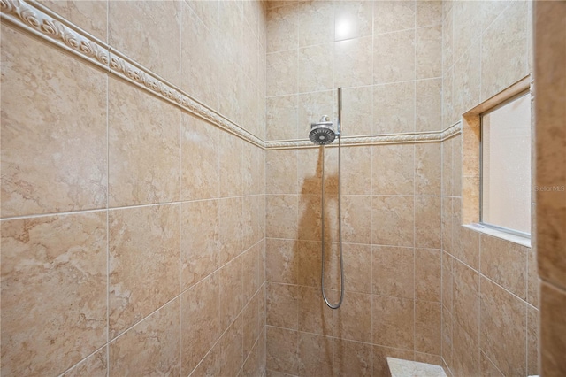 interior details with a tile shower