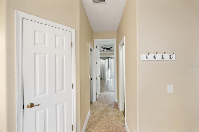 hallway with a textured ceiling