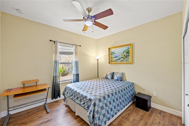 bedroom with hardwood / wood-style floors and ceiling fan