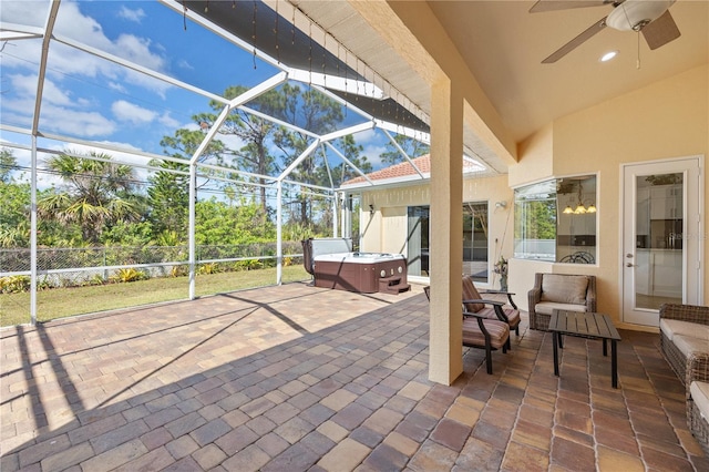 view of patio featuring a hot tub, a lanai, outdoor lounge area, and ceiling fan