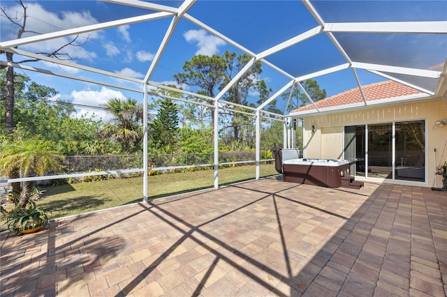 view of patio featuring a hot tub and a lanai