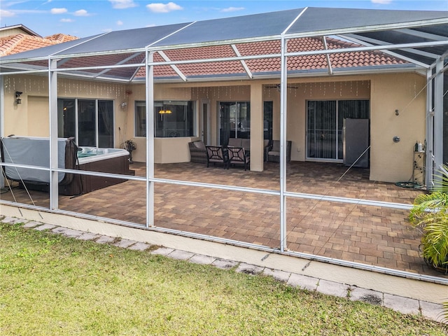 rear view of property featuring a lanai and a patio