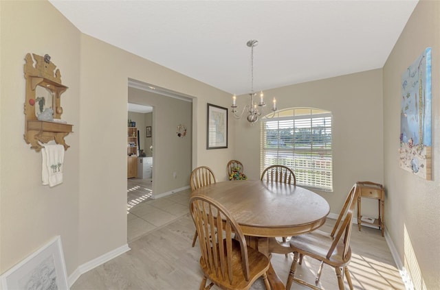 dining area featuring an inviting chandelier and light hardwood / wood-style flooring