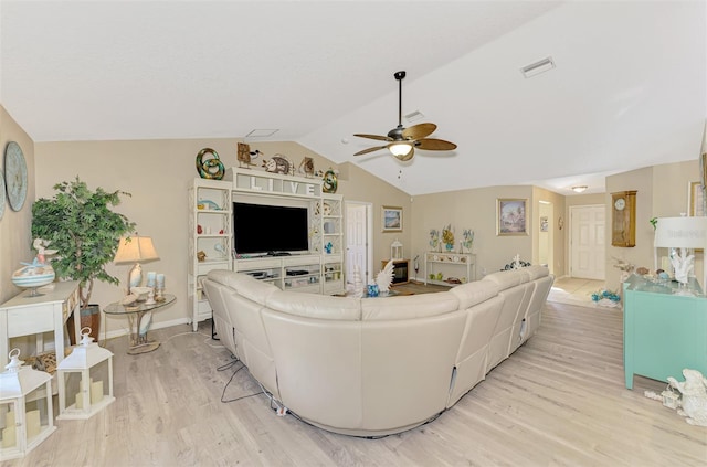 living room with ceiling fan, lofted ceiling, and light hardwood / wood-style flooring