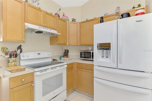 kitchen with light tile patterned floors, light brown cabinetry, and white appliances