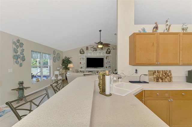 kitchen featuring vaulted ceiling, ceiling fan, sink, and light brown cabinets