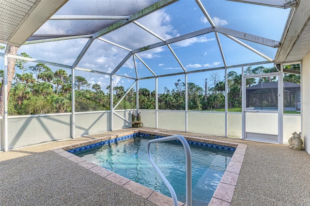 view of pool featuring a patio and glass enclosure