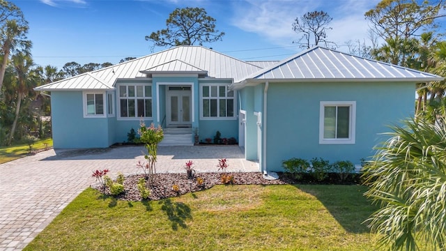 view of front of house with a front lawn and french doors